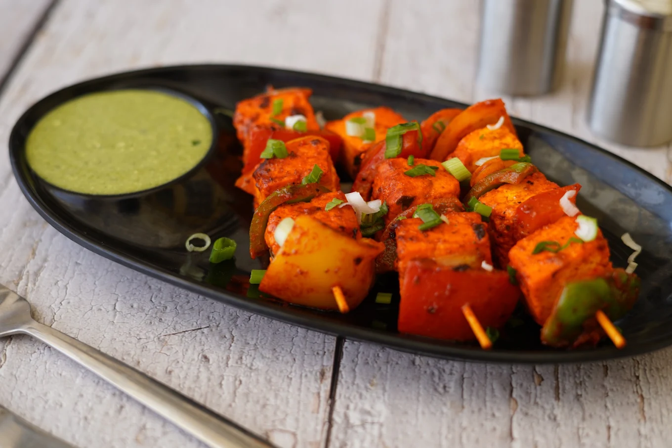 Grilled paneer and vegetable skewers with green chutney