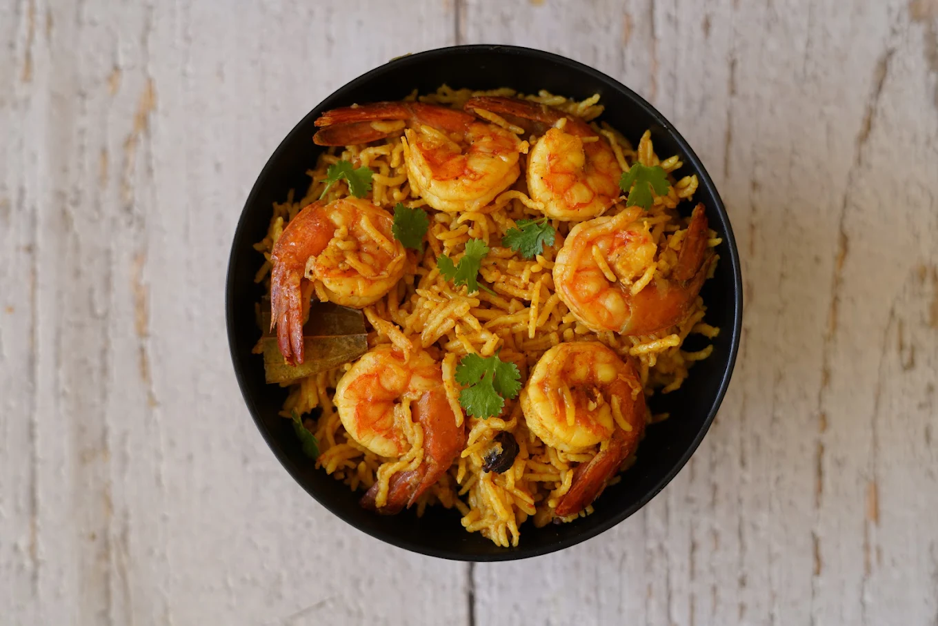 Prawn rice in a black bowl